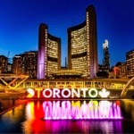 The new City Hall, Toronto Star Stage, reflecting pool, and 3D Toronto sign in Nathan Phillips Square, Toronto, Ontario, Canada.