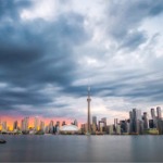 The Toronto skyline at sunset from Centre Island. The CN Tower and Rogers Centre feature in the middle of the photo.