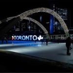 People ice skating at night in Nathan Phillips Square in Toronto, Ontario, Canada. There is a nice view of the 3D Toronto sign in the background.