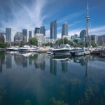 Toronto skyline with a marina and Lake Ontario in the foreground.