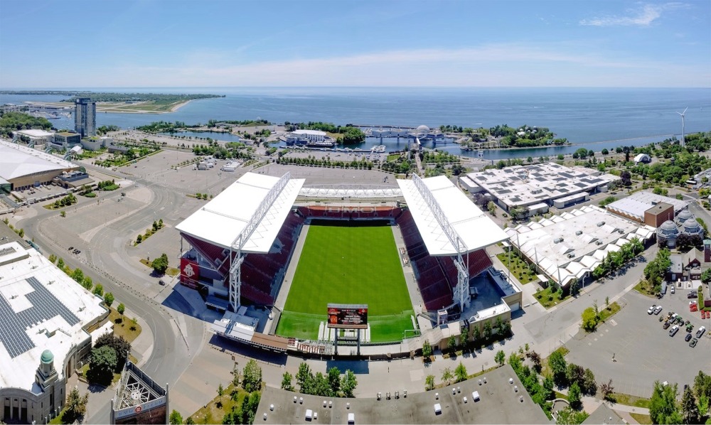 Photograph of the BMO Field, Exhibition Place, the IMAX Cinesphere at Ontario Place on the shore of Lake Ontario, and the Billy Bishop Toronto City Airport.
