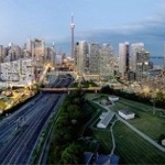 Cityscape of the central business district of Toronto featuring the CN Tower and the Gardiner Expressway.