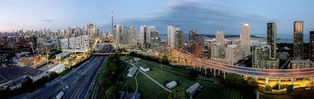 Cityscape of the central business district of Toronto featuring the CN Tower and the Gardiner Expressway.