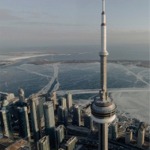 High-angle close-up photograph looking down at the CN Tower in the wintertime in Toronto, Ontario, Canada.