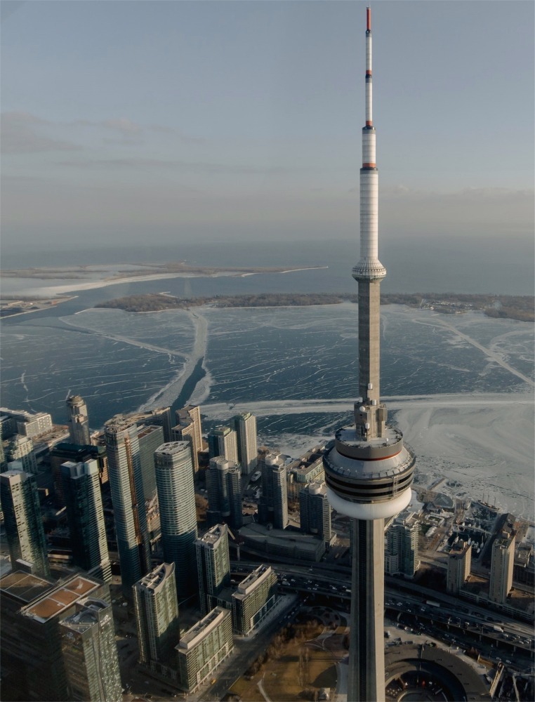 High-angle close-up photograph looking down at the CN Tower in the wintertime in Toronto, Ontario, Canada.