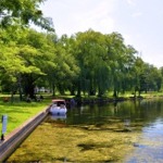 Photograph from the park on Centre Island, Toronto, Ontario, Canada. We see a pleasure craft moored in the pond.