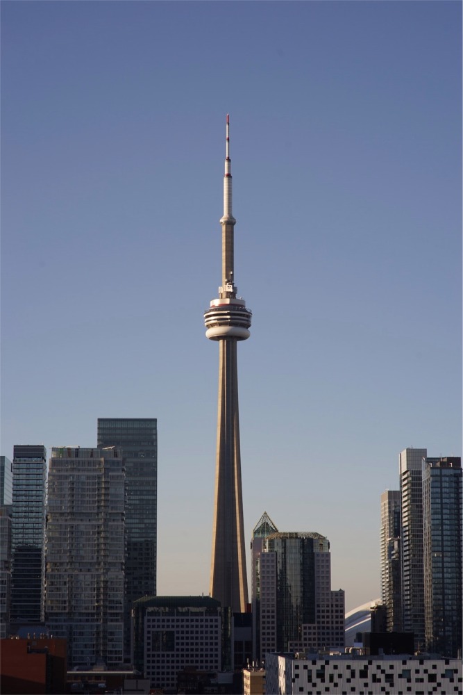 The CN Tower from the Grange Park neighbourhood of Toronto, Ontario, Canada on a bright sunny day.