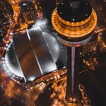 High-angle photograph that shows the Rogers Centre and the CN Tower at night in Toronto, Ontario, Canada.