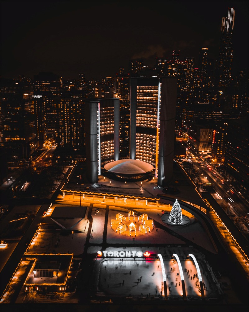 Nathan Phillips Square, the Star Stage, 3D Toronto sign, reflecting pool, and the City Hall, Toronto, Ontario, Canada.