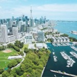 Downtown Toronto cityscape. We see Coronation Park and the Alexandra Yacht Club and Marina.