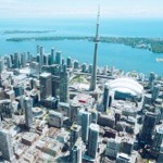 Downtown Toronto cityscape including the CN Tower, Rogers Centre, Round House Park & the Toronto Railway Museum, and Ripley's Aquarium of Canada.