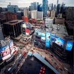 Toronto Ontario downtown cityscape with Yonge–Dundas Square in the foreground and a Goodyear blimp overhead.