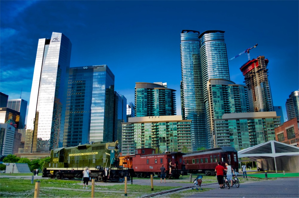 The Toronto Railway Museum at Roundhouse Park in Ontario, Canada is beautifully photographed in a stunning colour palette of blues, greens, and reds.